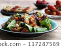 A vibrant, tempting breakfast with colorful salad, shrimp, ripe tomato, sandwich, bananas, fresh strawberries. Wholesome meal offers a delicious nutrients, providing energy, essential vitamin, healthy 117287569