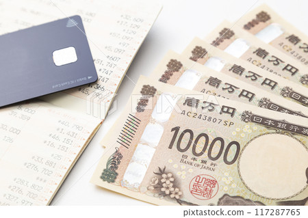 Bankbook and 10,000 yen bill on white background 117287765