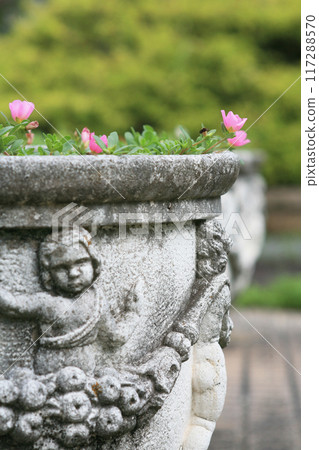 Planter and pink flowers in the park 117288570
