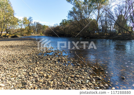 A serene natural waterway supporting local wildlife and community activities A serene natural waterway supporting local wildlife and community activities 117288880