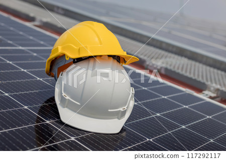engineer hard hat placed on the solar panel 117292117