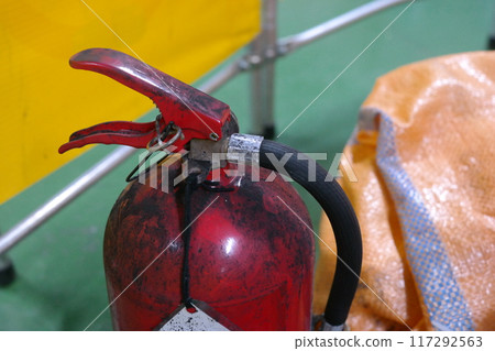 Fire extinguisher covered in black soot 117292563