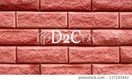 D2C word written D2C short for Direct to Consumer. Business concept, D2C on a red decorative brick 117293842