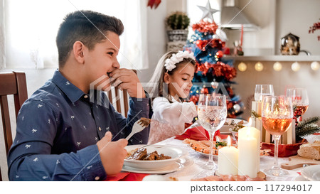 Happy kids during Christmas lunch 117294017