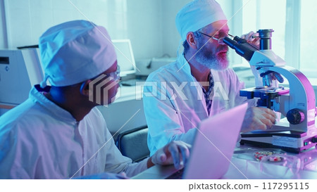 A chemist conducts analysis on chemical compounds using advanced equipment in a modern laboratory filled with vibrant technology. 117295115