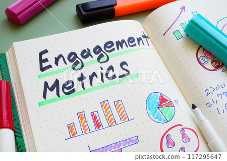 Engagement metrics charts in a notebook. Analysis of marketing performance. Engagement metrics charts in a notebook. Analysis of marketing performance. 117295647