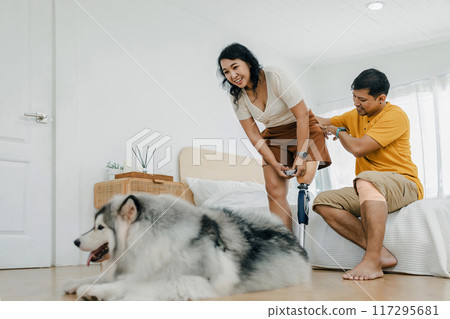 Couple bonding and smiling while sitting in at home 117295681