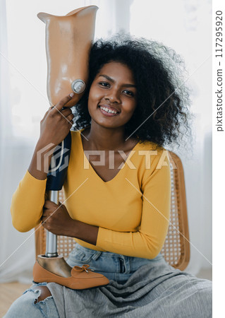 Woman hug prosthetic leg livingroom. applying leg prosthetic concept Woman hug prosthetic leg livingroom. applying leg prosthetic concept 117295920