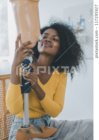 Woman hug prosthetic leg livingroom. applying leg prosthetic concept 117295927