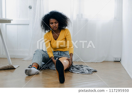 Woman hug prosthetic leg livingroom. applying leg prosthetic concept Woman hug prosthetic leg livingroom. applying leg prosthetic concept 117295930