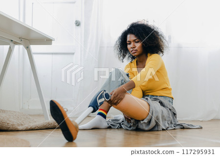 Woman hug prosthetic leg livingroom. applying leg prosthetic concept Woman hug prosthetic leg livingroom. applying leg prosthetic concept 117295931