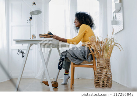 Woman hug prosthetic leg livingroom. applying leg prosthetic concept 117295942