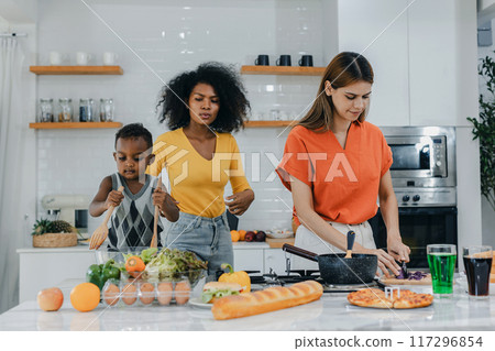 Pride LGBT Family at the kitchen Happy face. Happy smiling family having fun cooking at kitchen together Pride LGBT Family at the kitchen Happy face. Happy smiling family having fun cooking at kitchen together 117296854