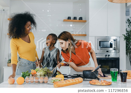 Pride LGBT Family at the kitchen Happy face. Happy smiling family having fun cooking at kitchen together 117296856