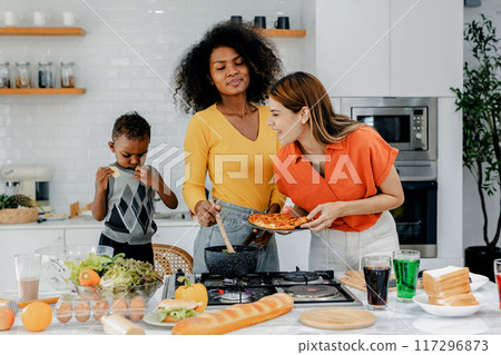 Pride LGBT Family at the kitchen Happy face. Happy smiling family having fun cooking at kitchen together 117296873