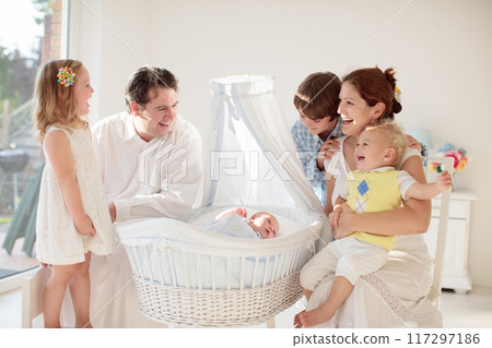 Family with kids playing with newborn baby Family with kids playing with newborn baby 117297186