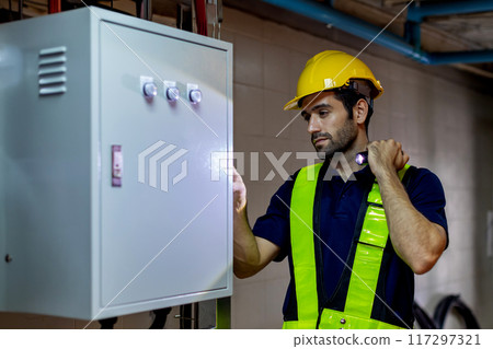 Electrical engineer man checking Power Distribution Cabinet in the control room 117297321