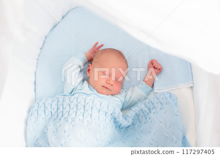 Newborn baby boy in white bassinet Newborn baby boy in white bassinet 117297405