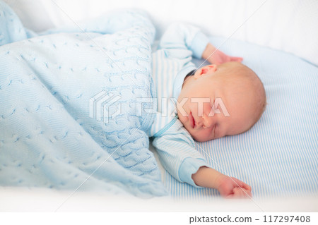 Newborn baby boy in white bassinet Newborn baby boy in white bassinet 117297408