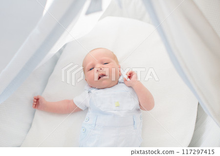 Little baby on white bed 117297415