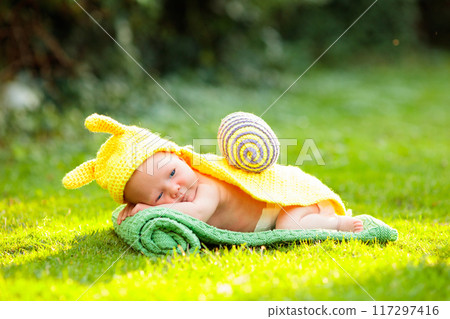 Baby in cute dress up costume. Newborn in garden. 117297416
