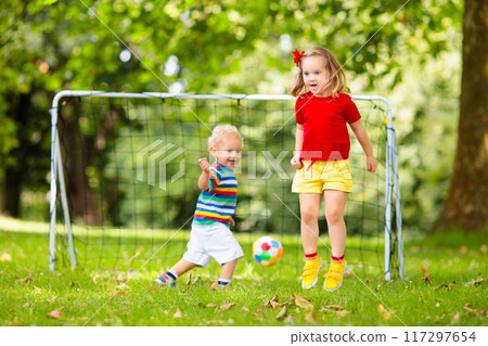 Child playing football. Kids play soccer. 117297654