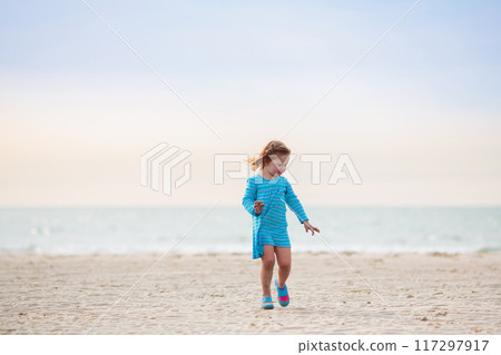 Kids playing on beach. Children play at sea. 117297917