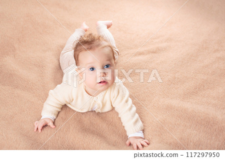 Little baby on white bed 117297950
