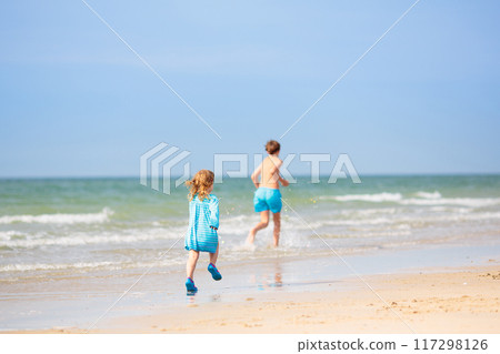 Kids playing on beach. Children play at sea. 117298126