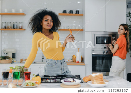 Happy smiling family having fun cooking at kitchen together Happy smiling family having fun cooking at kitchen together 117298167