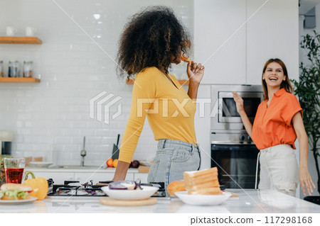 Happy smiling family having fun cooking at kitchen together Happy smiling family having fun cooking at kitchen together 117298168
