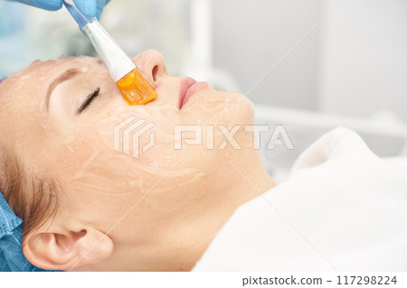 Dermatology anti age treatment. Applying gel with brush. Microcurrent 117298224
