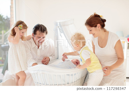 Family with kids playing with newborn baby 117298347