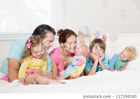 Family with kids playing with newborn baby Family with kids playing with newborn baby 117298380
