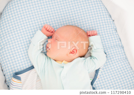 Little baby on white bed Little baby on white bed 117298410