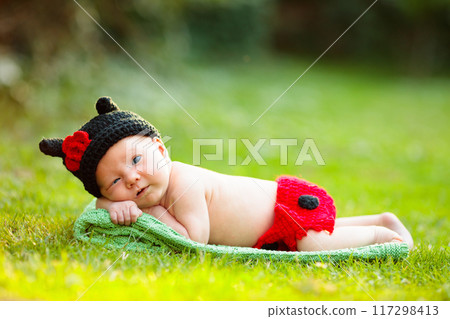 Baby in cute dress up costume. Newborn in garden. Baby in cute dress up costume. Newborn in garden. 117298413
