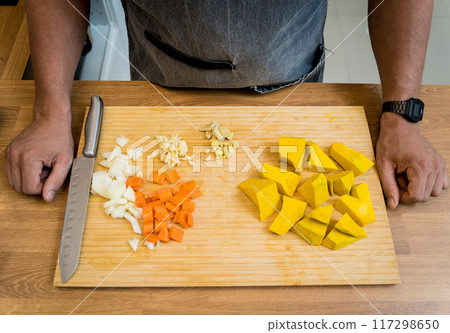 Chef at the kitchen preparing pumpkin porridge with tofu and vegetables Chef at the kitchen preparing pumpkin porridge with tofu and vegetables 117298650