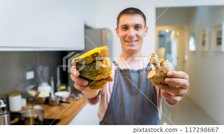 Chef at the kitchen preparing pumpkin porridge with tofu and vegetables 117298667