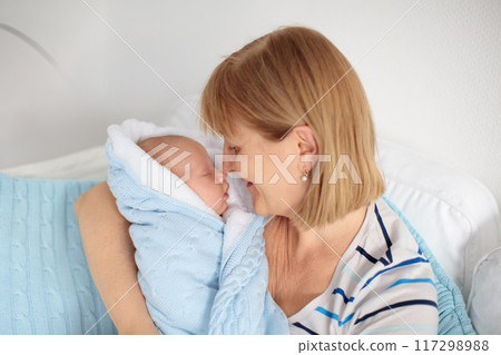 Grandmother holding newborn baby. Grandmother holding newborn baby. 117298988