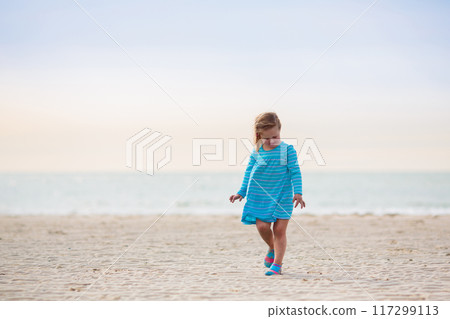 Kids playing on beach. Children play at sea. Kids playing on beach. Children play at sea. 117299113