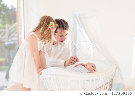 Family with kids playing with newborn baby Family with kids playing with newborn baby 117299150