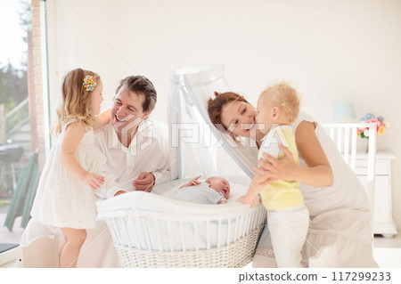 Family with kids playing with newborn baby 117299233
