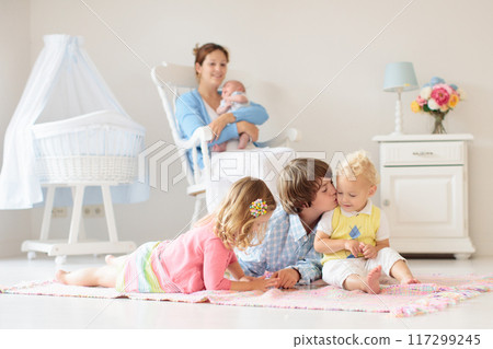 Family with kids playing with newborn baby 117299245