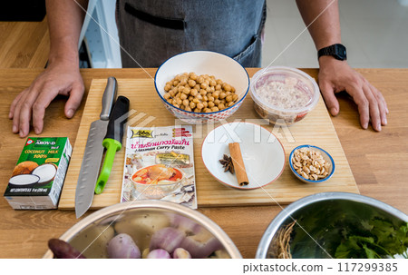 Chef at the kitchen preparing massaman curry with sweet potato and many spices 117299385