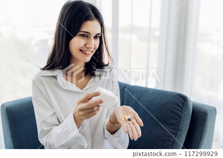 Woman sit down on sofa.healthcare virus protection. health and fever concept. 117299929