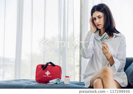 Woman sit down on sofa.healthcare virus protection. health and fever concept. 117299930