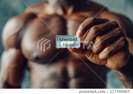 Man with an athletic physique holding steroids - portrayal of the potential risks and ethical considerations surrounding performance-enhancing substances in sports and fitness culture. Man with an athletic physique holding steroids - portrayal of the potential risks and ethical considerations surrounding performance-enhancing substances in sports and fitness culture. 117300065