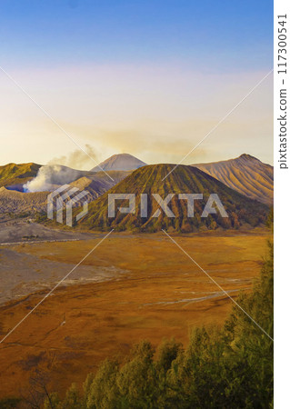 Dramatic sunrise over Mount Bromo, showcasing its volcanic cone. 117300541