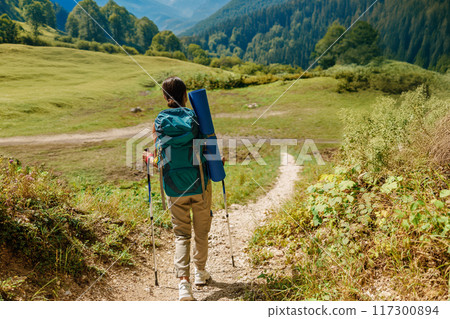 An Adventurous Hiker Exploring a Scenic Mountain Trail with a Durable Backpack Onboard 117300894