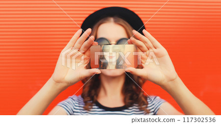 Close up of modern young woman stretching her hands taking selfie with smartphone on red background 117302536